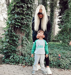 Full length of women standing by plants