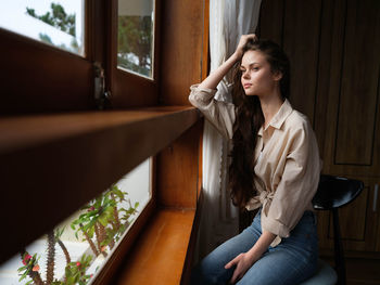 Side view of young woman sitting on staircase