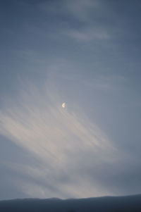 Low angle view of moon at sunset