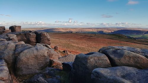 Scenic view of rocks on land against sky