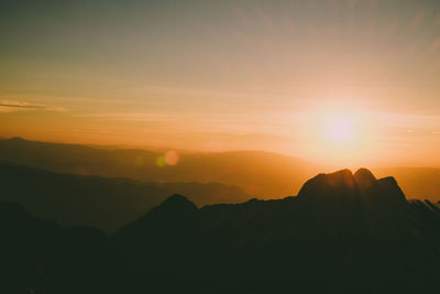 Scenic view of silhouette mountains against sky during sunset