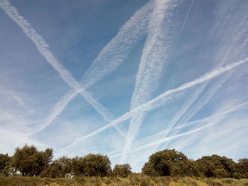 Low angle view of vapor trails in sky