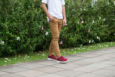 Low section of man standing on footpath