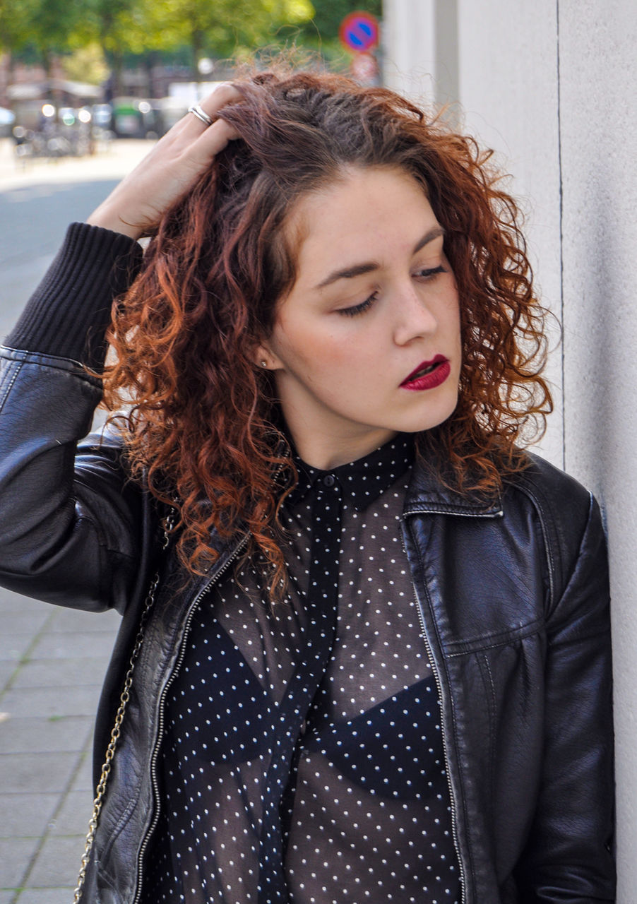 portrait, looking at camera, person, young adult, casual clothing, front view, lifestyles, young women, waist up, smiling, leisure activity, long hair, standing, three quarter length, focus on foreground, headshot, jacket