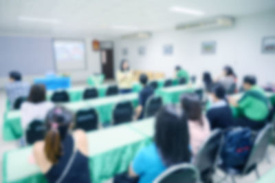 Defocused image of people sitting in stadium