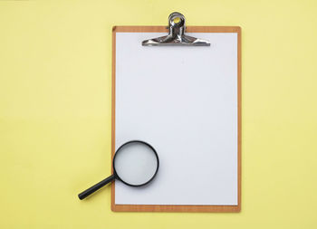 High angle view of electric lamp against yellow background