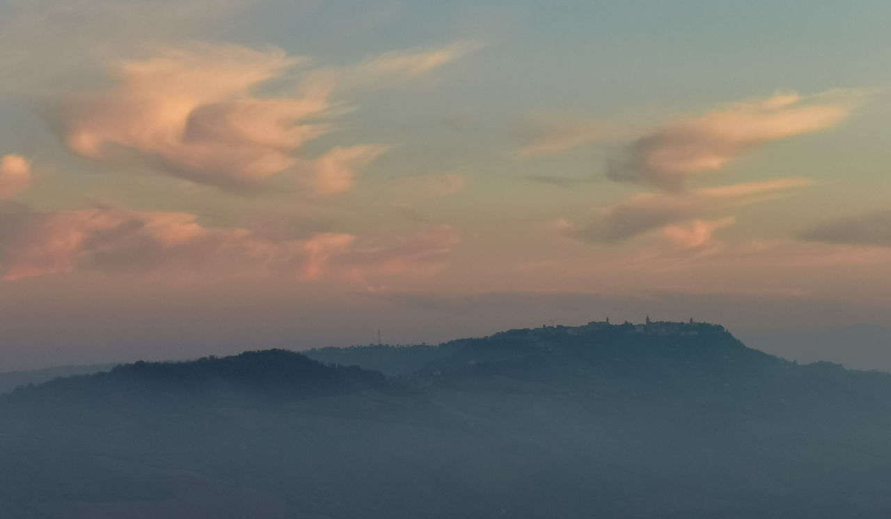 SCENIC VIEW OF MOUNTAINS AGAINST SKY AT SUNSET