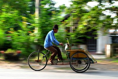 Man riding bicycle on road