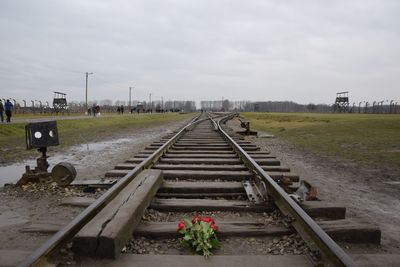 View of railroad tracks against cloudy sky