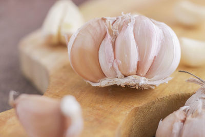 Close-up of garlic on cutting board in kitchen