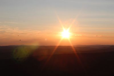 Silhouette landscape against sky during sunset