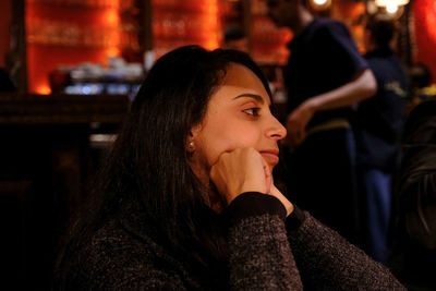 Thoughtful woman sitting in restaurant