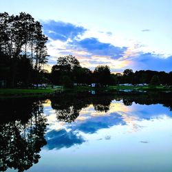 Reflection of trees in lake against sky