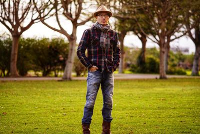 Portrait of young man standing on field