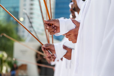 Traditional emirati al ayalah male dance, uae heritage, hands in frame