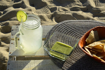 Lemonade with lime slice, green salsa and tortilla chips afternoon snack at the beach