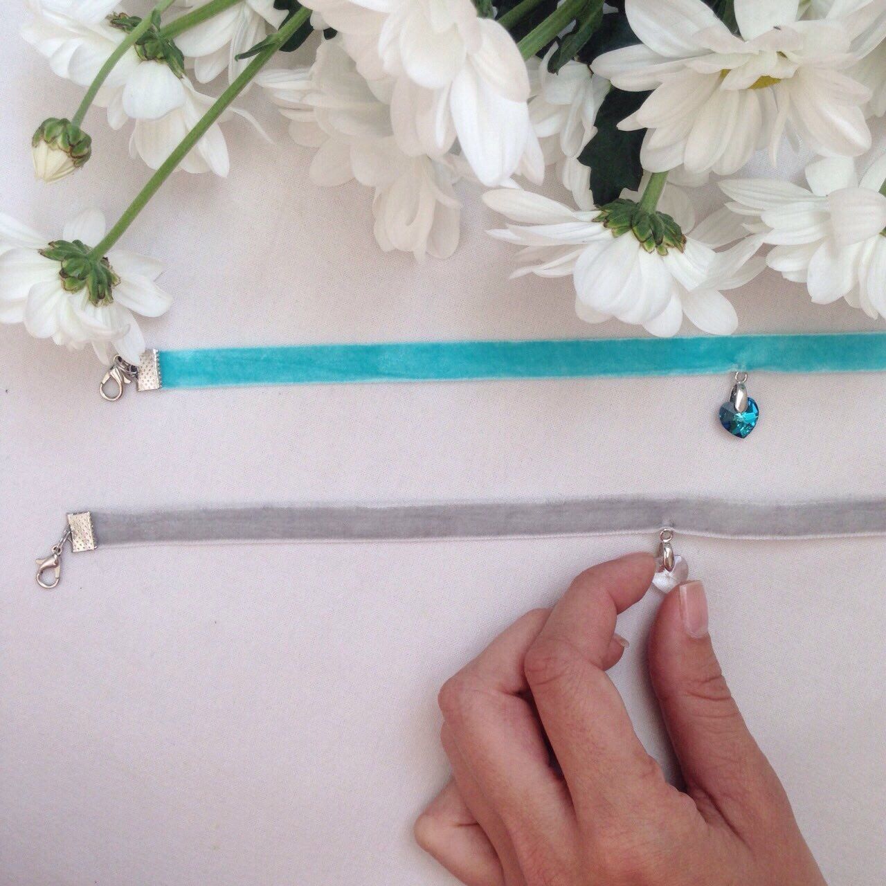 person, flower, part of, indoors, holding, cropped, fragility, close-up, petal, freshness, human finger, white color, studio shot, unrecognizable person, high angle view, flower head