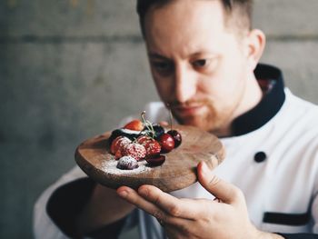 Close-up of man holding cake