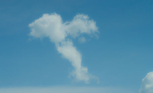 Low angle view of smoke emitting from blue sky