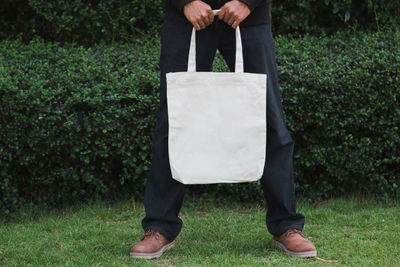 Man holding bag canvas fabric for mockup,ecology concept.