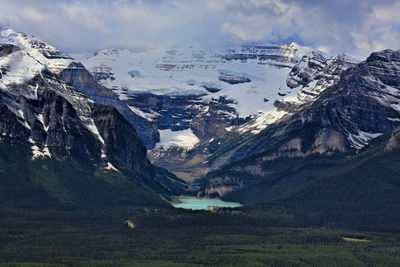 Aerial view of snowcapped mountains against sky