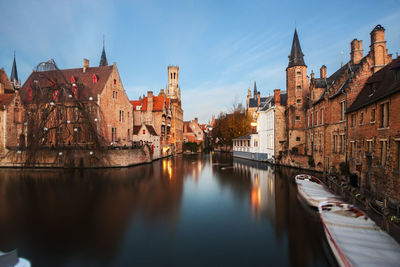 River amidst buildings against sky in city