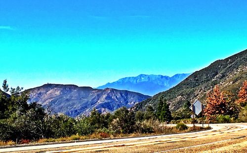 Scenic view of mountains against clear blue sky