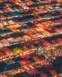 High angle view of colorful tents at market during night