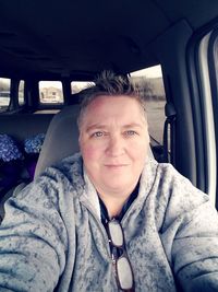 Portrait of man sitting in car