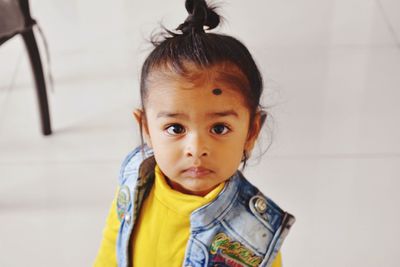 Portrait of cute boy standing on floor