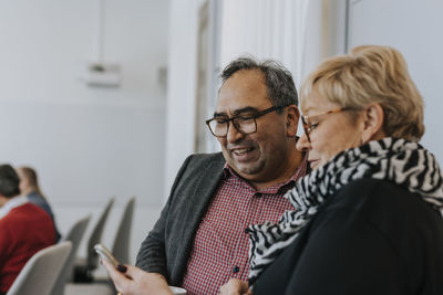 People looking at cell phone during meeting