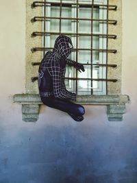 Man with umbrella on window