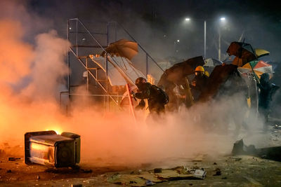 Panoramic view of people on fire at night