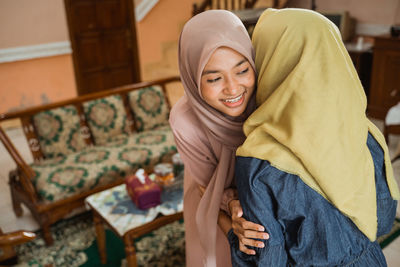 Happy women embracing at home