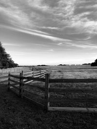 Fence on field against sky