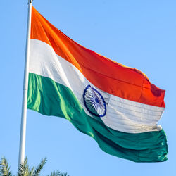 India flag flying high at connaught place with pride in blue sky, india flag fluttering, indian flag