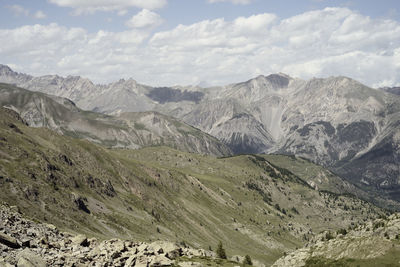 Scenic view of mountains against cloudy sky