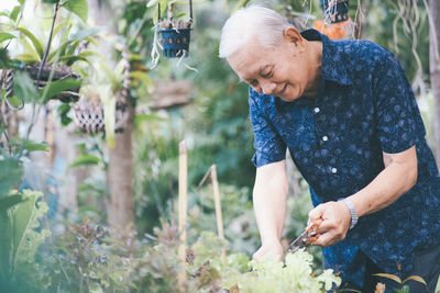 Full length of woman standing against plants