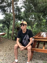 Portrait of young man sitting in park