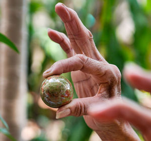 Cropped hand holding small ball