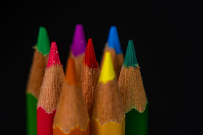 Close-up of multi colored pencils against black background