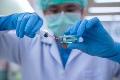 Rear view of people holding mobile phone