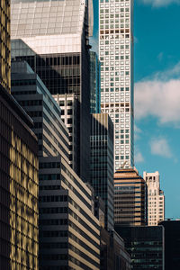 Low angle view of modern buildings in city against sky