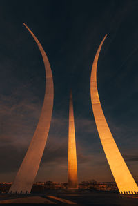 Low angle view of illuminated bridge against sky at sunset