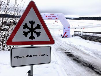 Close-up of snow covered road sign