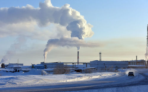 Smoke emitting from chimney against sky