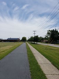 Road by plants against sky