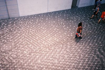 High angle view of people walking on footpath