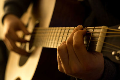 Cropped image of person playing guitar