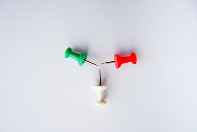 Close-up of colored pencils over white background